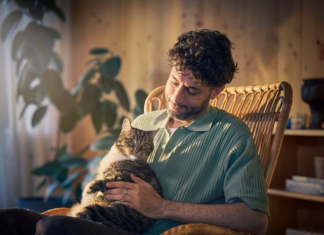 Man med katt i knät